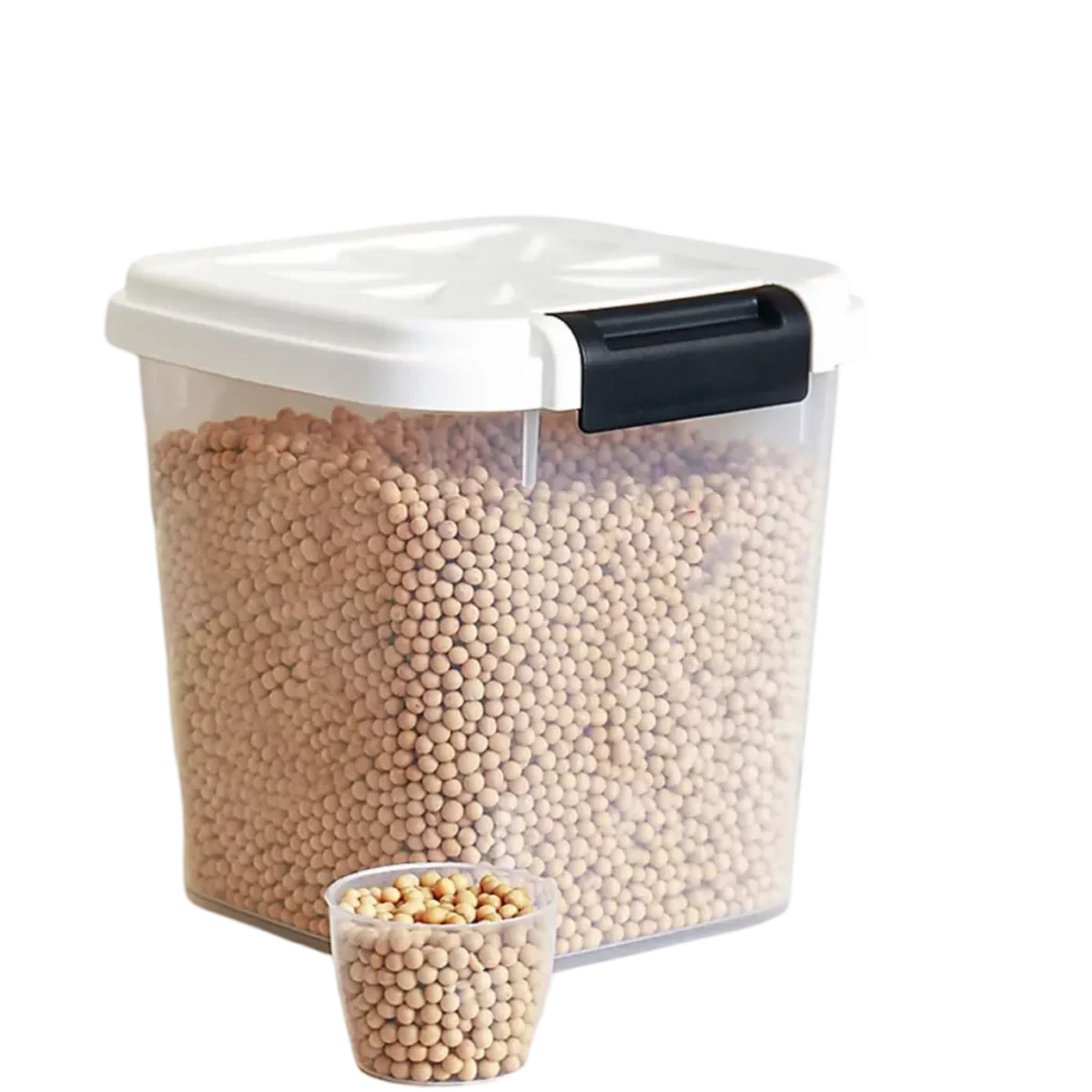 Transparent storage container filled with beige spherical legumes and a small cup in front.