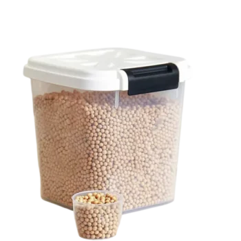 A clear square container filled with beige legumes and a white lid with black handle.